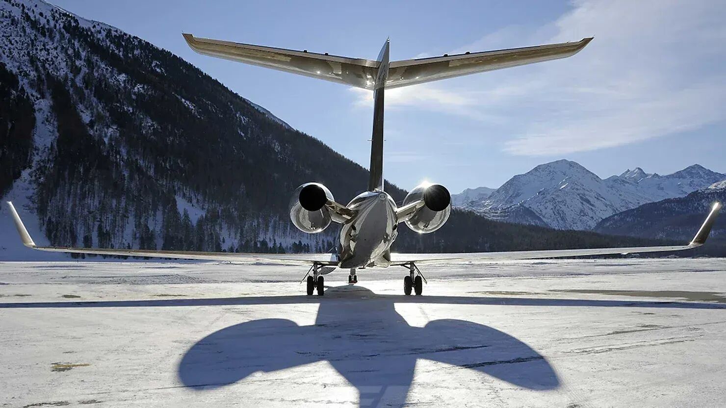 Private jet in front of snowy mountains