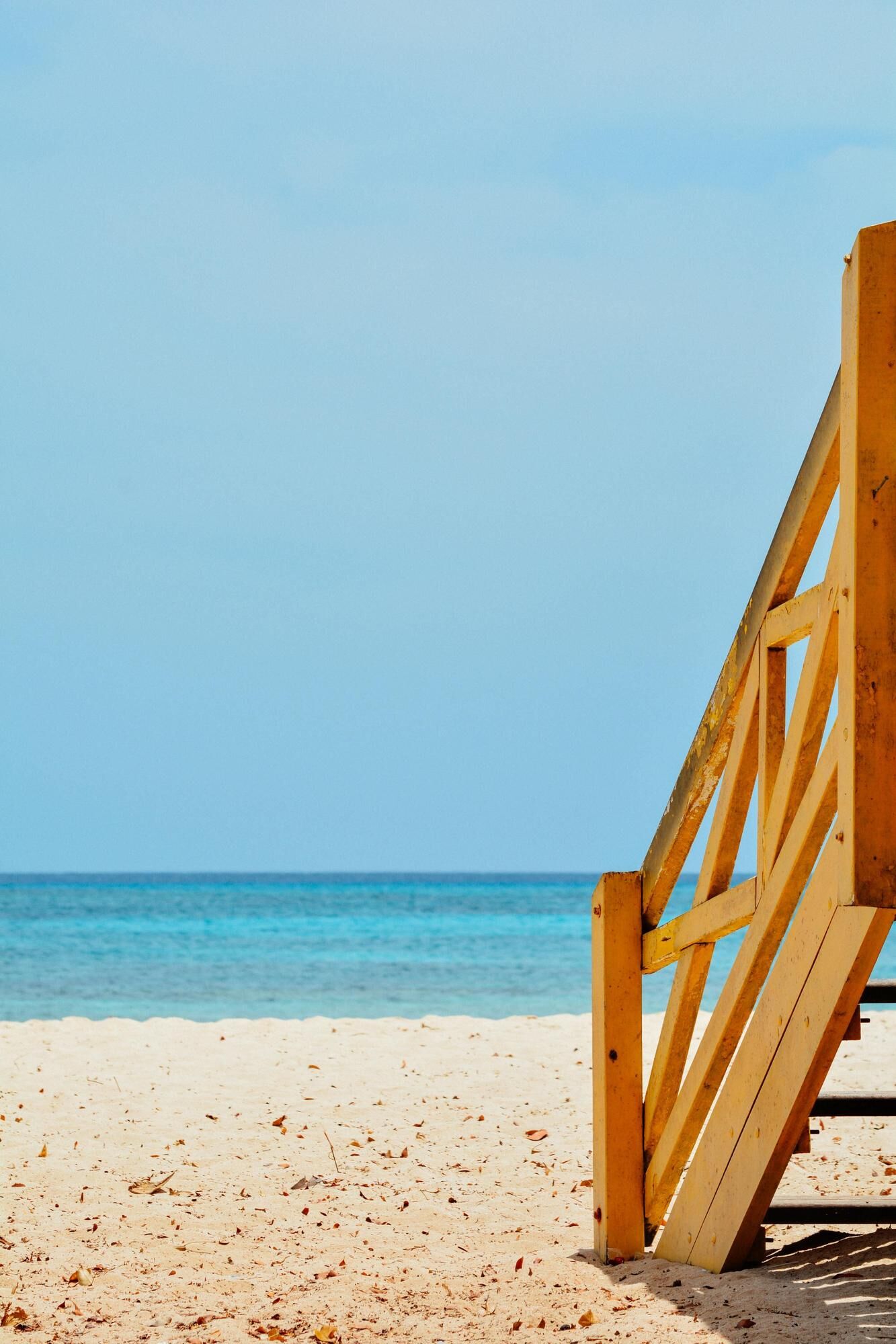 Steps down to a beach in Barbados and clear skies with water that goes on for miles