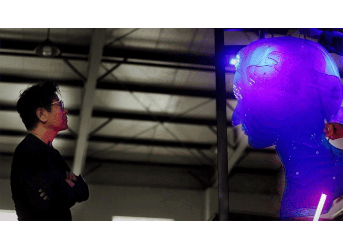 The artist LI Jiwei looking at his installation