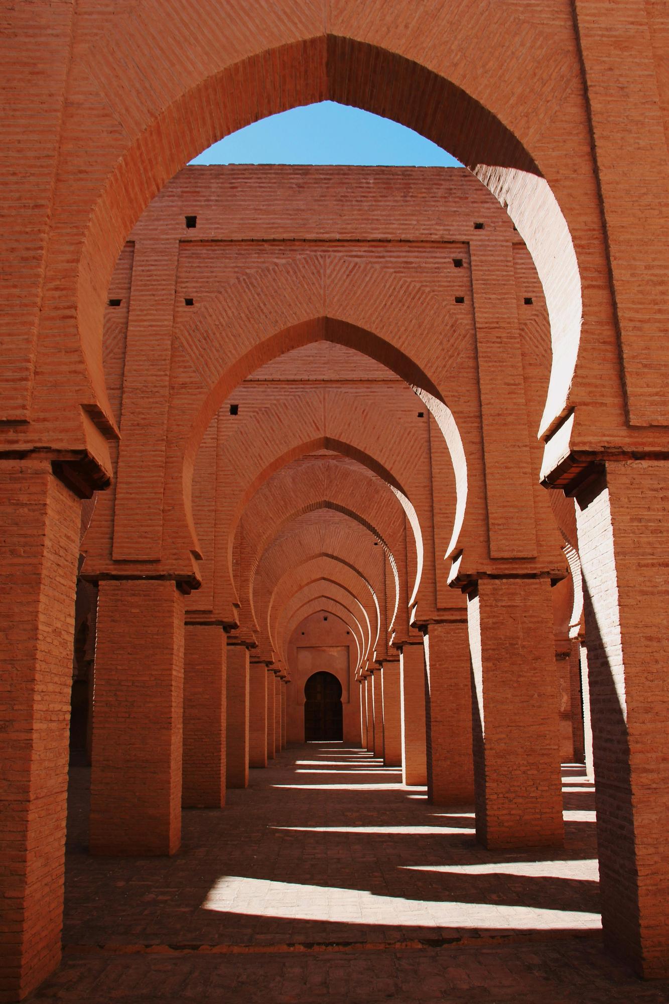 A long walkway that showcases beautiful Moroccan architecture