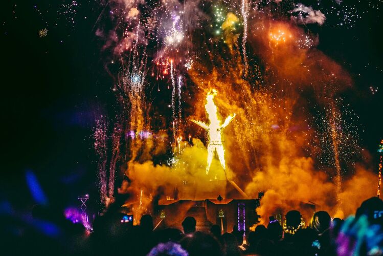 Firework explosion and Burning Man effigy set alight to mark the end of the festival at night