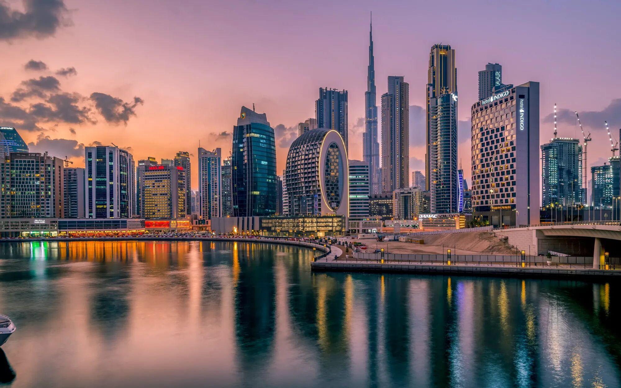 Dubai skyscapers at night reflecting on the water