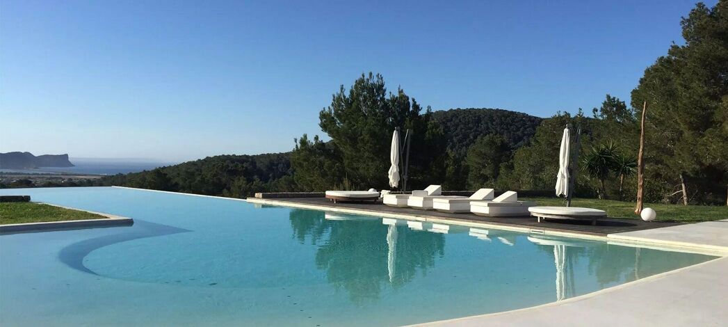 Beautifully manicured lawns and infinity swimming pool at Bluemoon's Villa Margo in Ibiza