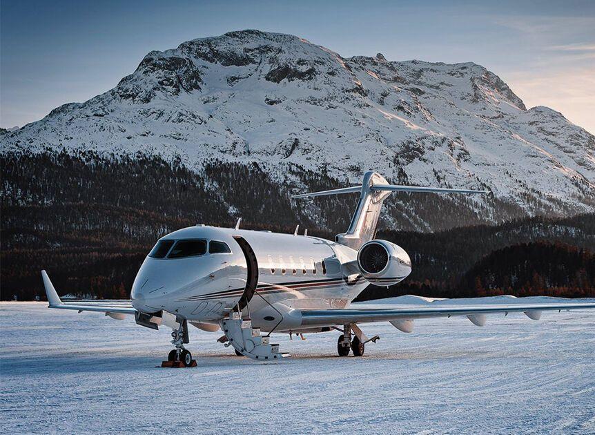 Charter Private Jet ready for take off in front of mountains