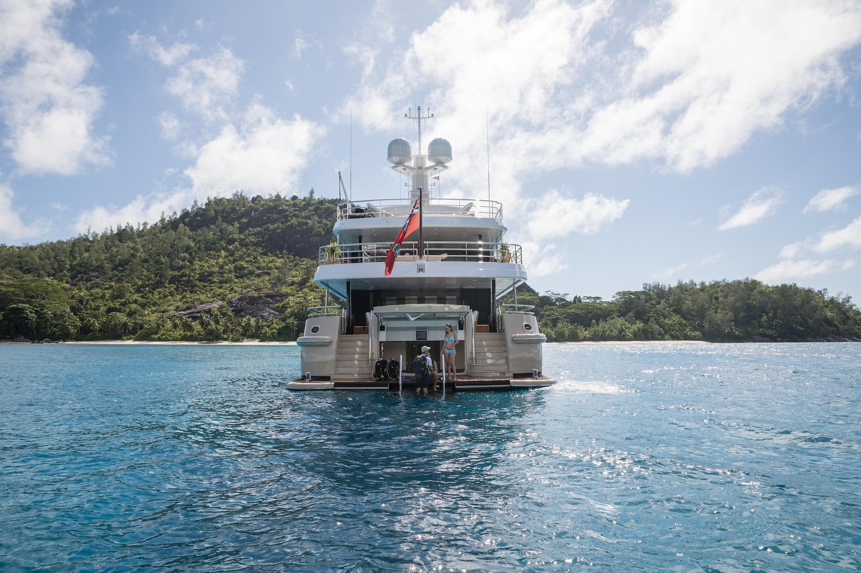The stern of super yacht Amigos at anchor with Bluemoon