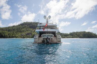 The stern of super yacht Amigos at anchor with Bluemoon
