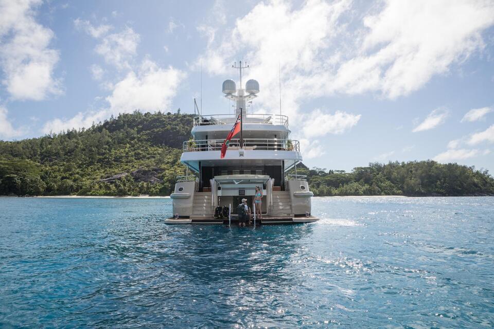The stern of super yacht Amigos at anchor with Bluemoon