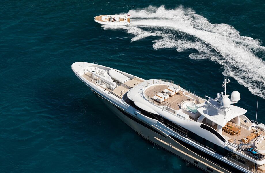 Motor yacht Amigos's tender zipping around the bow of the incredible charter yacht