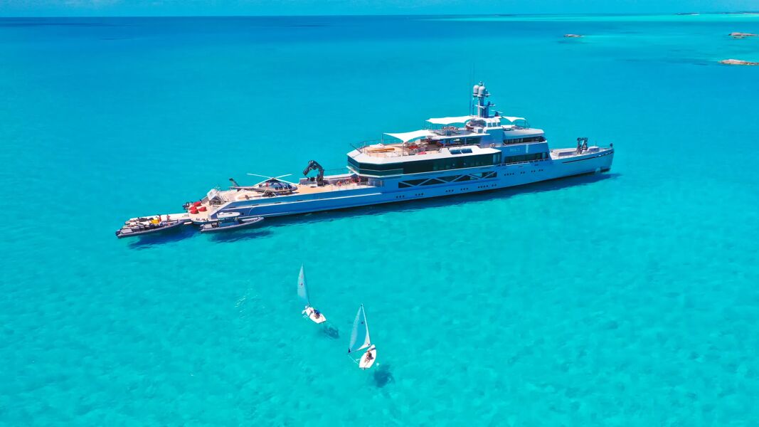 Starboard view of motor yacht Bold with the helicopter on the helipad chartering with Bluemoon