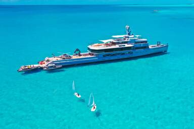 Starboard view of motor yacht Bold with the helicopter on the helipad chartering with Bluemoon