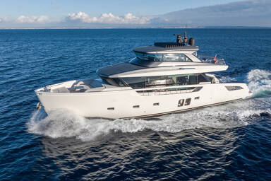 Port view of charter yacht Cloud IX sailing through the sea leaving waves behind it