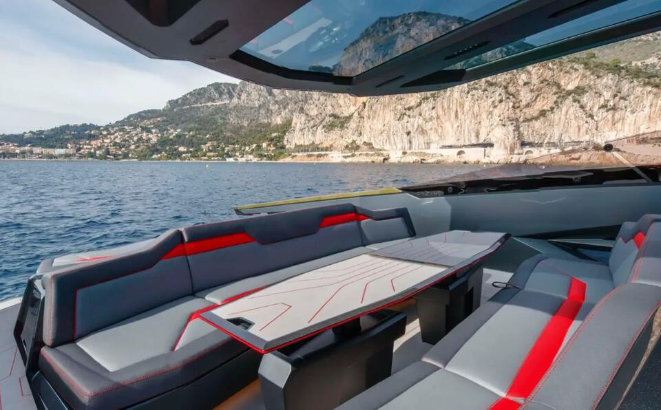 Additional seating area on board charter yacht Fast One with view of cliffs in the background