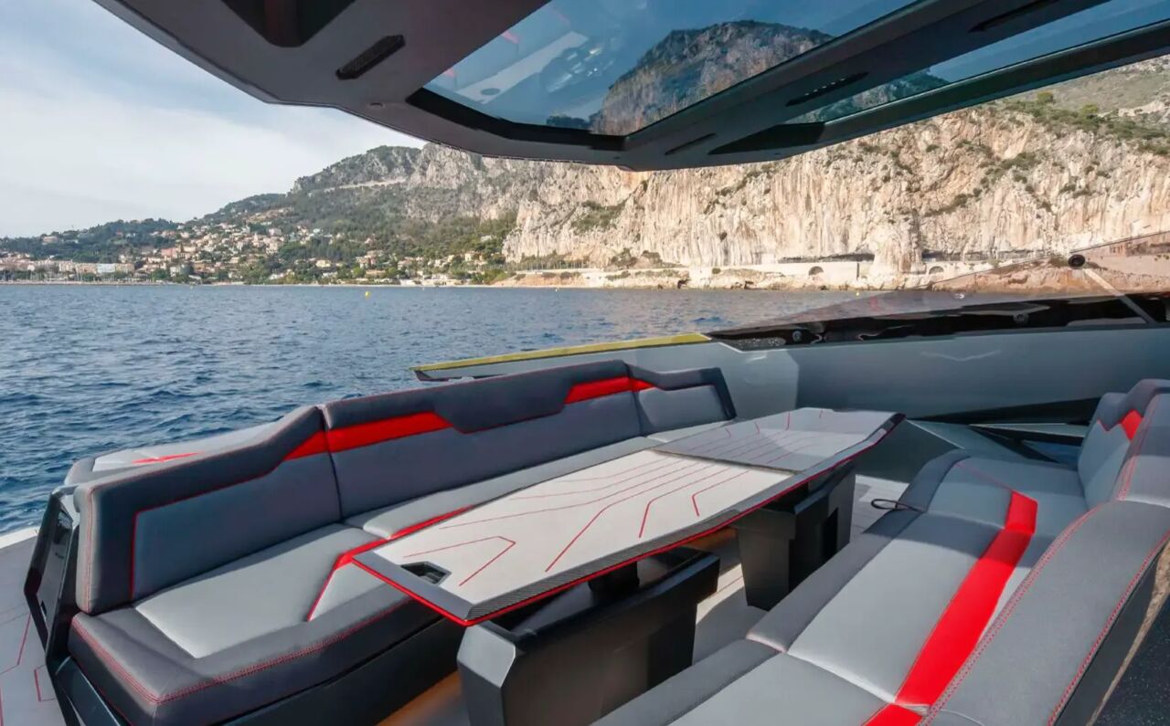 Additional seating area on board charter yacht Fast One with view of cliffs in the background