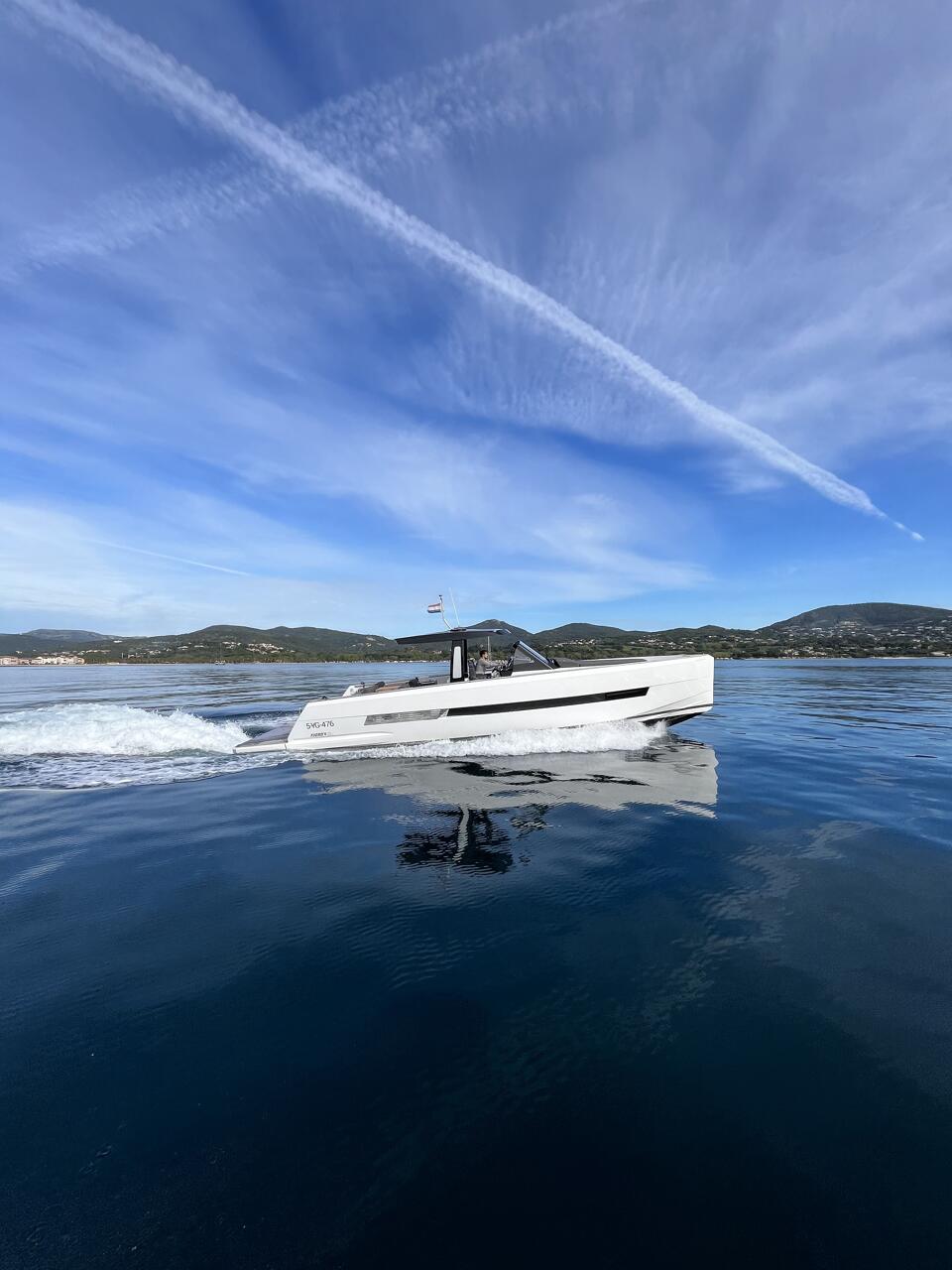 Starboard side of Fjord 44 Open peacefully sailing with plane flying above it