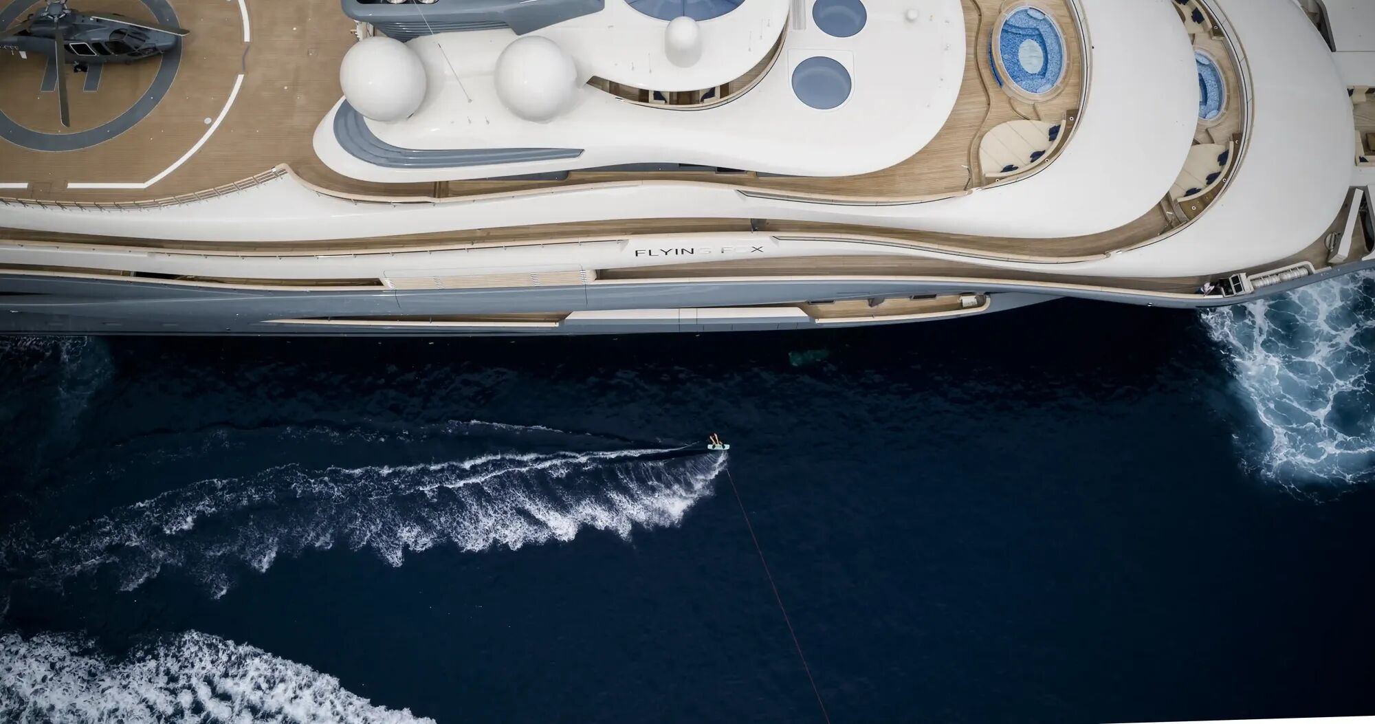 Aerial view of Flying Fox's starboard with the charter yachts logo on show on charter with Bluemoon