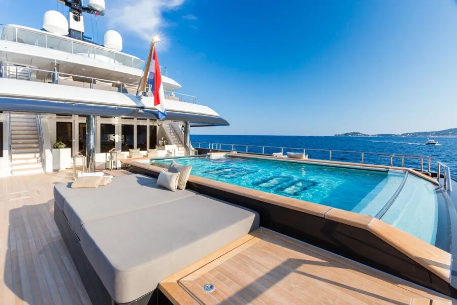 Swimming pool aboard motor yacht Loon with comfortable seating next to it