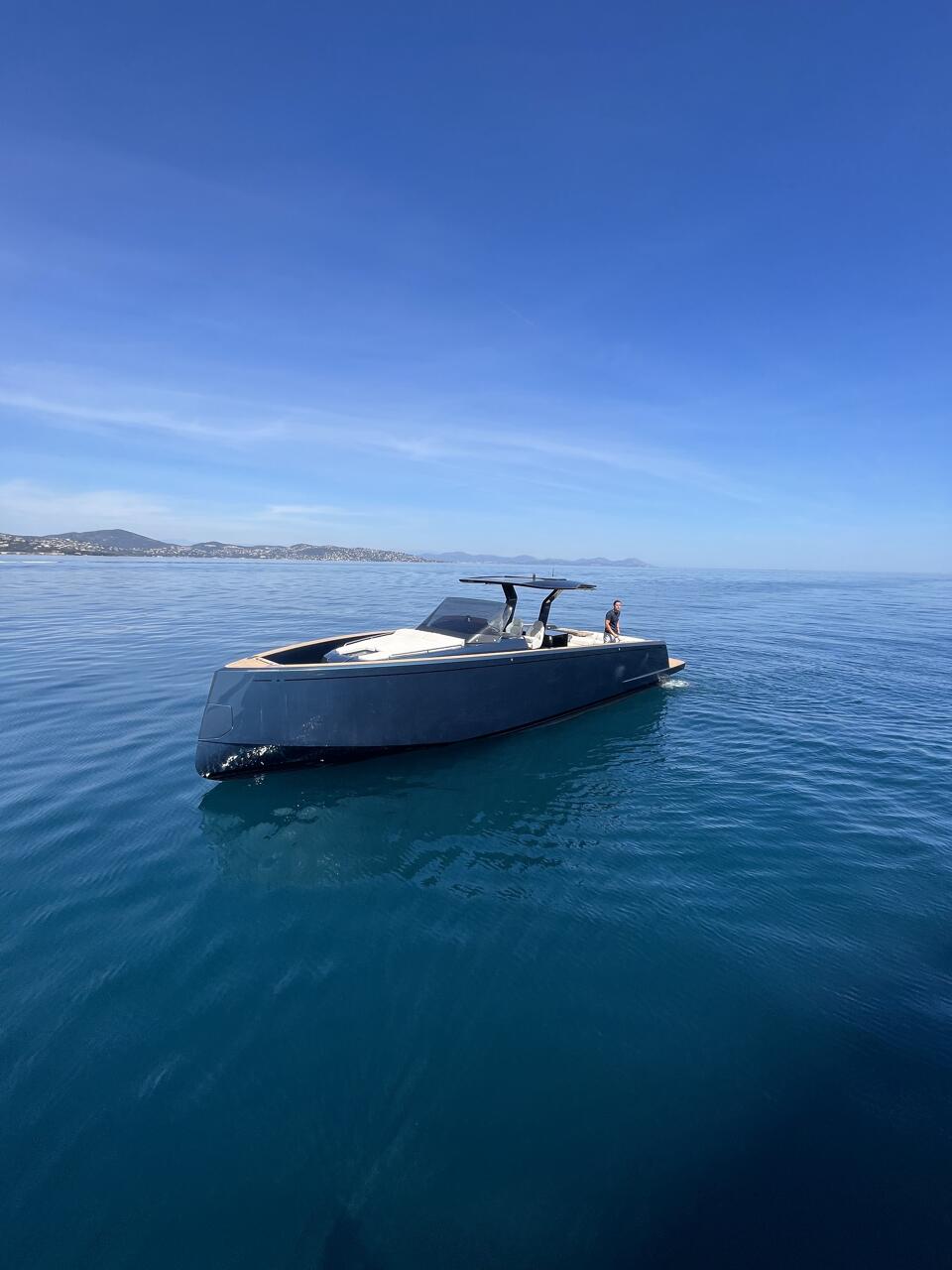 Bow view of Pardo 43 at anchorage surrounded by beautiful water and tall mountains with Captain aboard