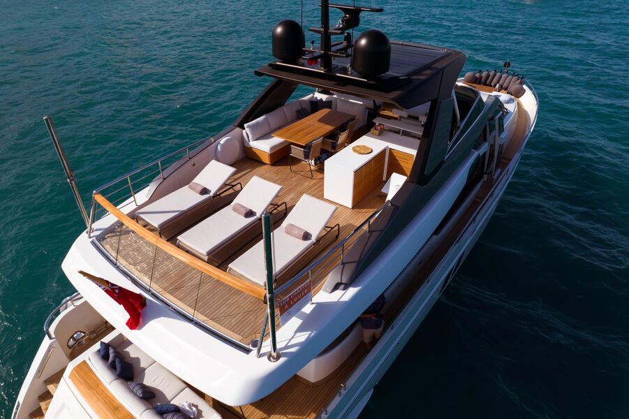 Aerial view of the weather deck on board Triple L with sun loungers and a covered alfresco dining area and bar