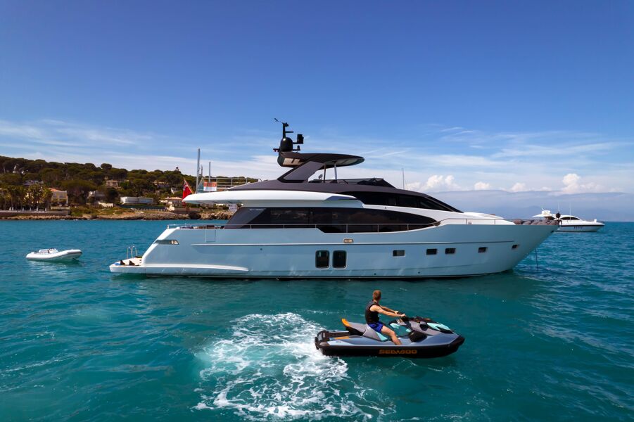 A charter guest jet skiing around motor yacht Triple L's starboard side at anchor