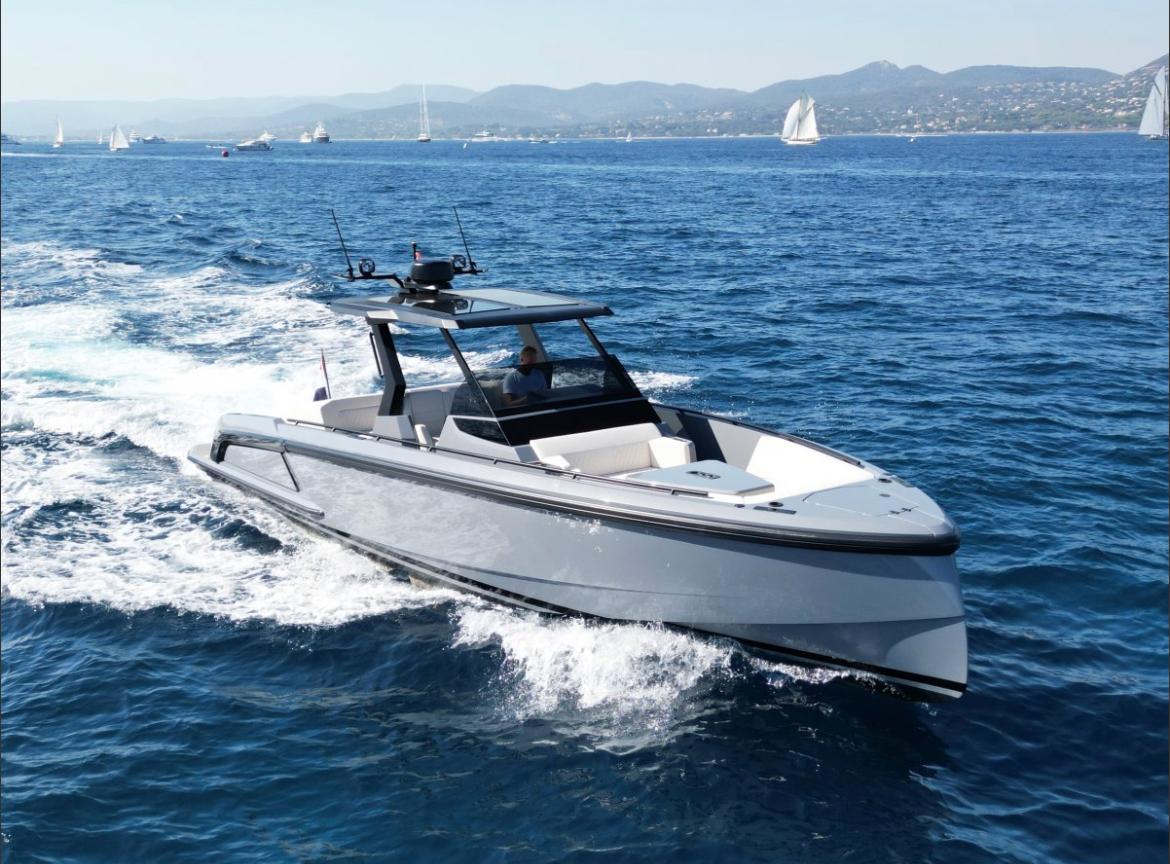 Starboard view of Vanquish 40 Sports Line sailing along the sea with mountains in the background