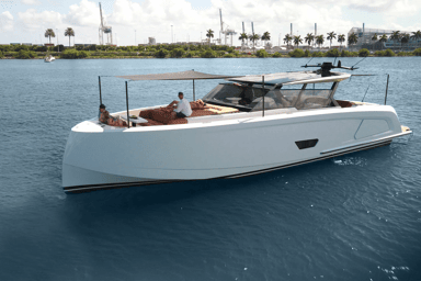 Starboard view on Vanquish 58 at anchor with guests relaxing on the bow