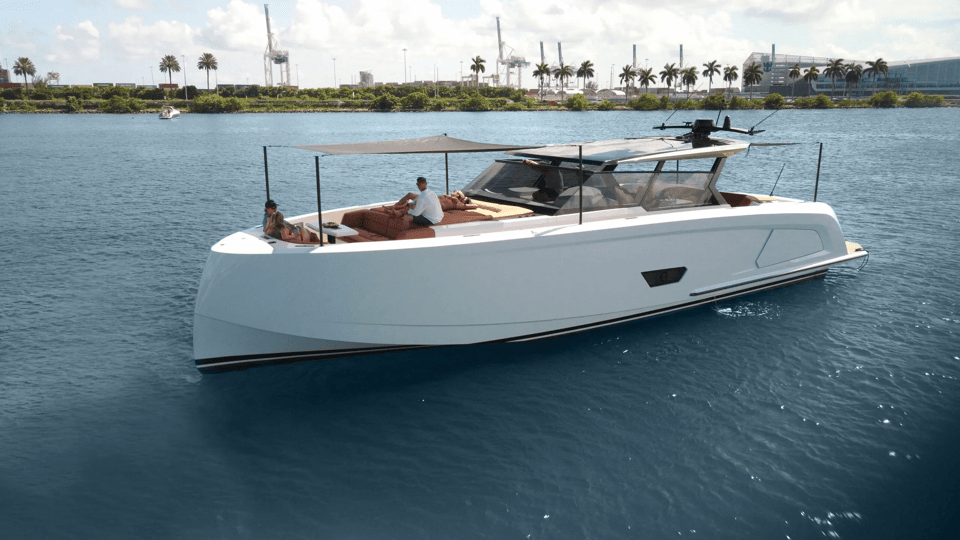Starboard view on Vanquish 58 at anchor with guests relaxing on the bow