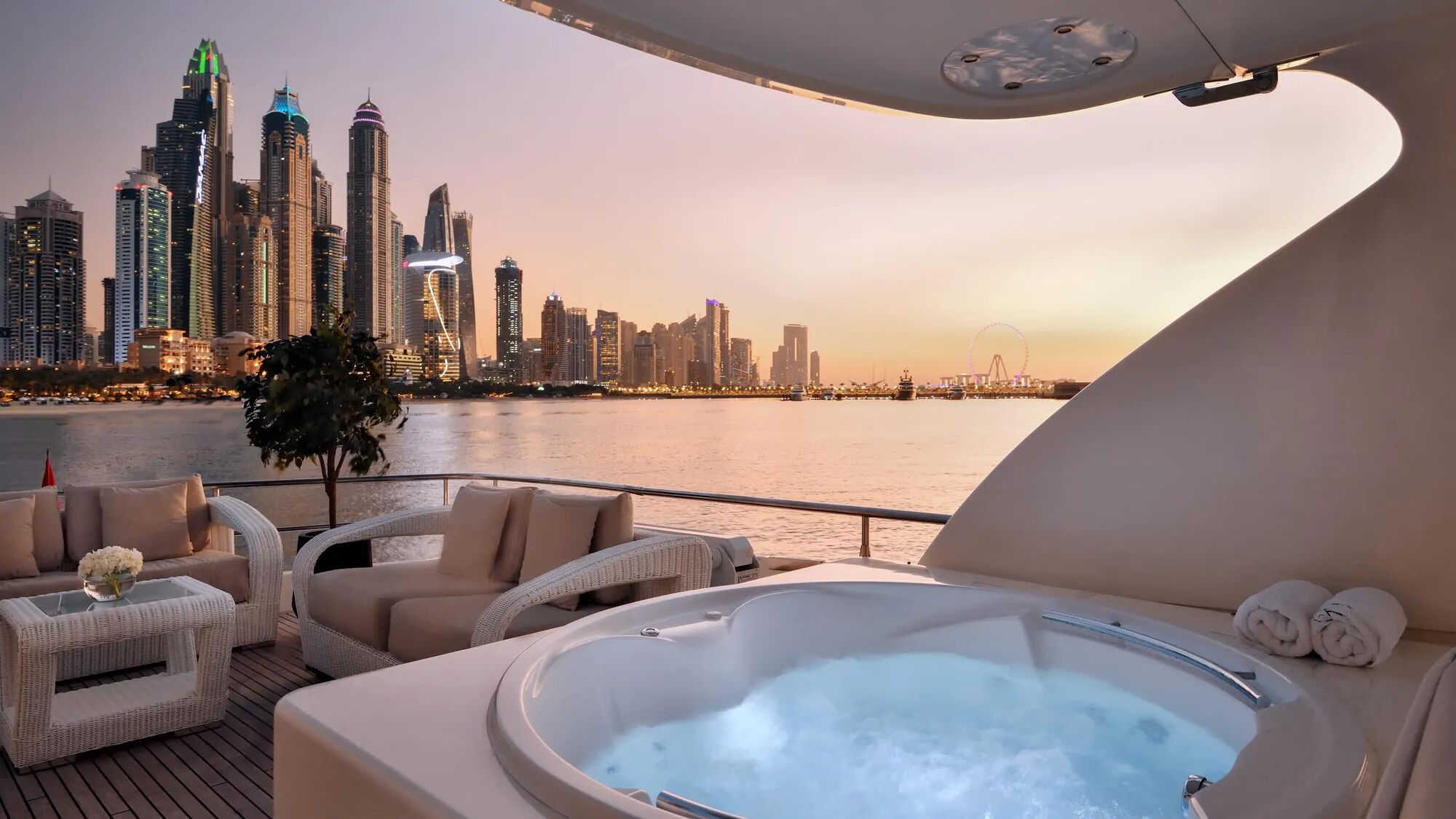 Jacuzzi on motor yacht Haigan at sunset with Dubai skyscrapers in the background