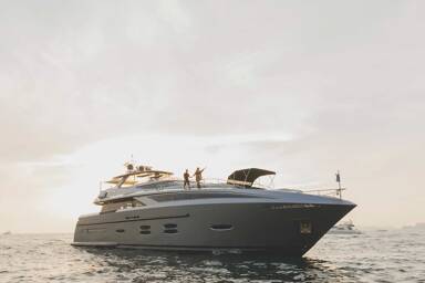 A couple on the bow of motor yacht Santorini available for charter with Bluemoon